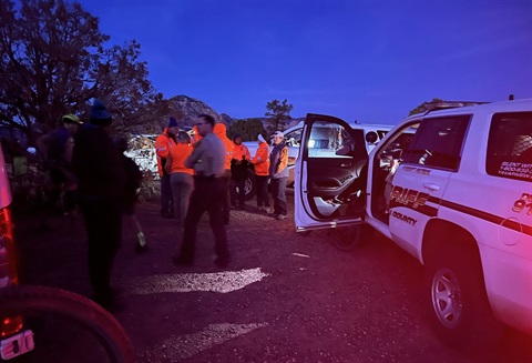 YCSO Deputies and Search and Rescue Volunteers at dusk outside at trailhead near YCSO Tahoe